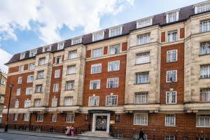 um grande edifício de tijolos com pessoas andando na frente dele em Classic Marble Arch Apartment em Londres