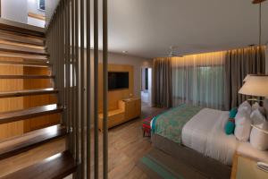 a hotel room with a bed and a television at Iguazu Jungle Lodge in Puerto Iguazú