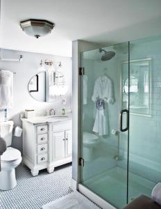 a bathroom with a shower and a toilet and a sink at Maxwell Mansion Hotel in Lake Geneva