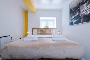 a bedroom with a large bed with two pillows on it at Yellow Bridge - 2 Bed Luxury Apartment in Amley