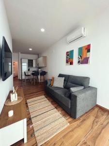 a living room with a couch and a table at Jasmine L7 in Armeñime
