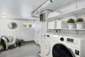 a white laundry room with a washing machine in it at Amazing Villa in Downtown Reykjavik in Reykjavík