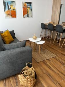 a living room with a couch and a table at Amber L5 in Armeñime