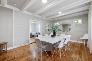 a dining room with a white table and chairs at Amazing Villa in Downtown Reykjavik in Reykjavík