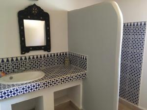 a bathroom with a sink and a mirror on the wall at CHATEAU D'ORIENT in Essaouira +18 photos