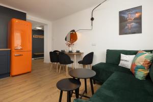 a living room with a green couch and a table at Stylish Apartment Warsaw Downtown by Renters in Warsaw