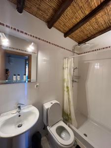 a white bathroom with a sink and a toilet at Quinta with orange and lemon trees in Silves