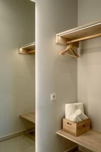 a walk in closet with wooden shelves and towels at SeãCret in Kolymvari
