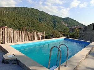a swimming pool with a mountain in the background at Green Garden in Ijevan