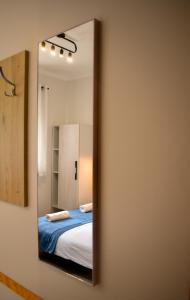 a bedroom with a bed and a mirror at Arcus Premium Hostel in Warsaw