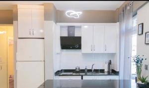 - une cuisine avec des placards blancs et un évier dans l'établissement Modern cozy beach apartment, à Payallar