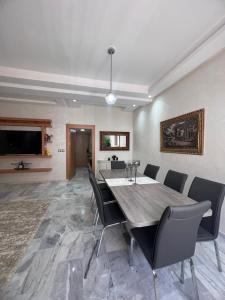 a dining room with a table and chairs at Antonios luxury apartments in Fez