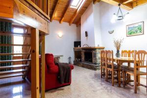 a living room with a table and a fireplace at Casa Xaupí 2 in Roní