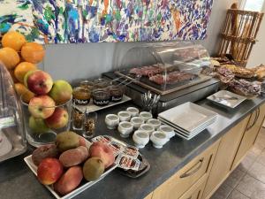 a kitchen counter with a bunch of food on it at Hôtel Des Argousiers in Ambleteuse