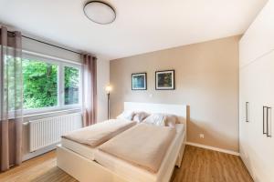 a bedroom with a bed and a large window at City-Luxus Apartment Rottweil in Rottweil