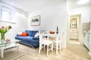 a living room with a blue couch and a table at Apartments Tereza in Dubrovnik