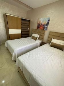 Postel nebo postele na pokoji v ubytování Immeuble Familial Imad