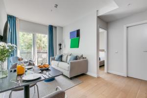 a living room with a table and a couch at Home Art Apartments Chamberí in Madrid