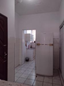 a kitchen with a white refrigerator in a room at APARTAMENTO BEACH in Fortaleza