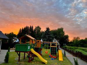 un parque con parque infantil con tobogán en Butenas Hotel Tyla en Biržai