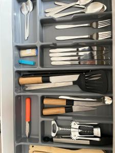 a plastic container filled with utensils in a drawer at Apartamencik przy Tężni w Konstancinie in Konstancin-Jeziorna