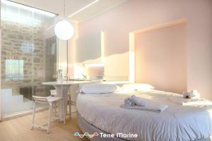 a bedroom with a bed and a table and a desk at Sea-Cret, TerreMarine in Manarola
