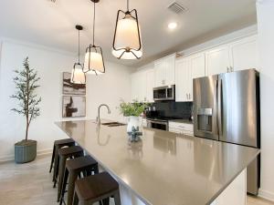 a kitchen with a large stainless steel refrigerator at Disney Villa w/ pool + FREE Pet Fee under 25lbs in Kissimmee