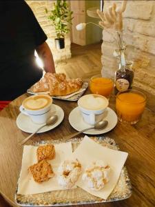 a table with two cups of coffee and plates of food at Palazzo Benucci in San Gimignano