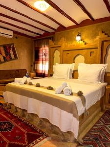 a bedroom with a large bed with towels on it at RIAD AMNAY in Taroudant