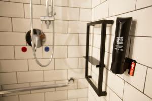 a shower with a blow dryer in a bathroom at ibis Cuiaba Shopping in Cuiabá