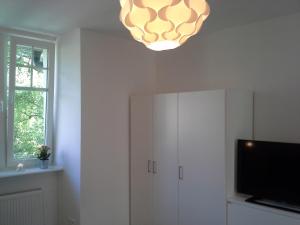 a living room with a tv and a chandelier at Sopot Baltic in Sopot