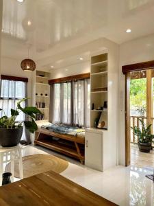 a living room with a bed in the window at Marhay Villa Siargao in General Luna