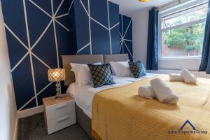 a bedroom with two beds with blue walls and a window at Premium Southampton Accommodations, Ideal for Relocators and Working Professionals #close to Southampton general hospital in Southampton