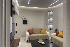 a living room with a couch and a table at Serenity apartment in Pyrgos