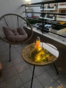 Dos sillas y una mesa con una vela. en Serenity apartment en Pýrgos