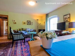 a living room with a couch and a table at Ferienwohnung im Landhaus Neparmitz in Poseritz