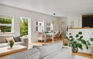 a living room with a couch and a table at Cozy Home In Dronningmlle With Kitchen in Dronningmølle