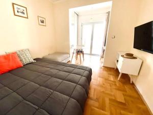a bedroom with a large bed and a flat screen tv at Buena Vista studio in Kotor