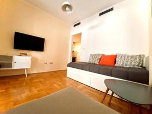 a living room with a couch and a flat screen tv at Buena Vista studio in Kotor