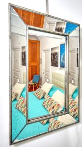 a mirror reflecting a bedroom with two beds at Acquaviva 31 in Capri