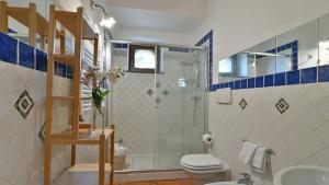 a bathroom with a shower and a toilet and a sink at VILLA BIDDIZZA 10, Emma Villas in Acireale +29 photos