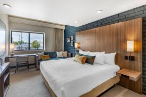 a hotel room with a bed and a desk at The Gibson Hotel Great Falls, Ascend Hotel Collection in Great Falls