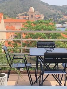 a table and chairs on a balcony with a view at La Terrasse in Port-Vendres