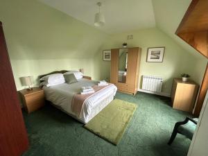 a bedroom with a large bed and a mirror at Taigh Na Casag in Lionel