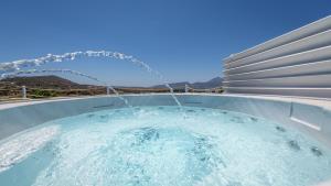 a hot tub with a water hose at Milion Fantasy House in Adamantas