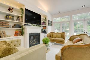 a living room with a fireplace and a tv at Spacious Durham Home with Fire Pit and Hot Tub! in Durham