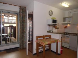 a small kitchen with a table and a counter top at Appartement Vieux Boucau in Vieux-Boucau-les-Bains