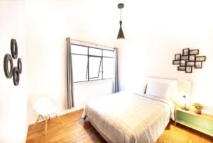 a bedroom with a bed and a large window at Insurgentes 7 in Mexico City