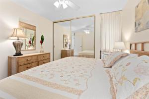a bedroom with a large bed and a mirror at Koa Lagoon 506 in Kihei +17 photos