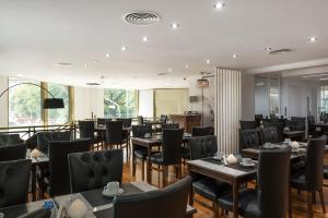 un restaurant avec des tables et des chaises dans une salle dans l'établissement Imperial Park Hotel, à Buenos Aires